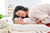 Babo Botanicals- Baby on changing table smiling with mom