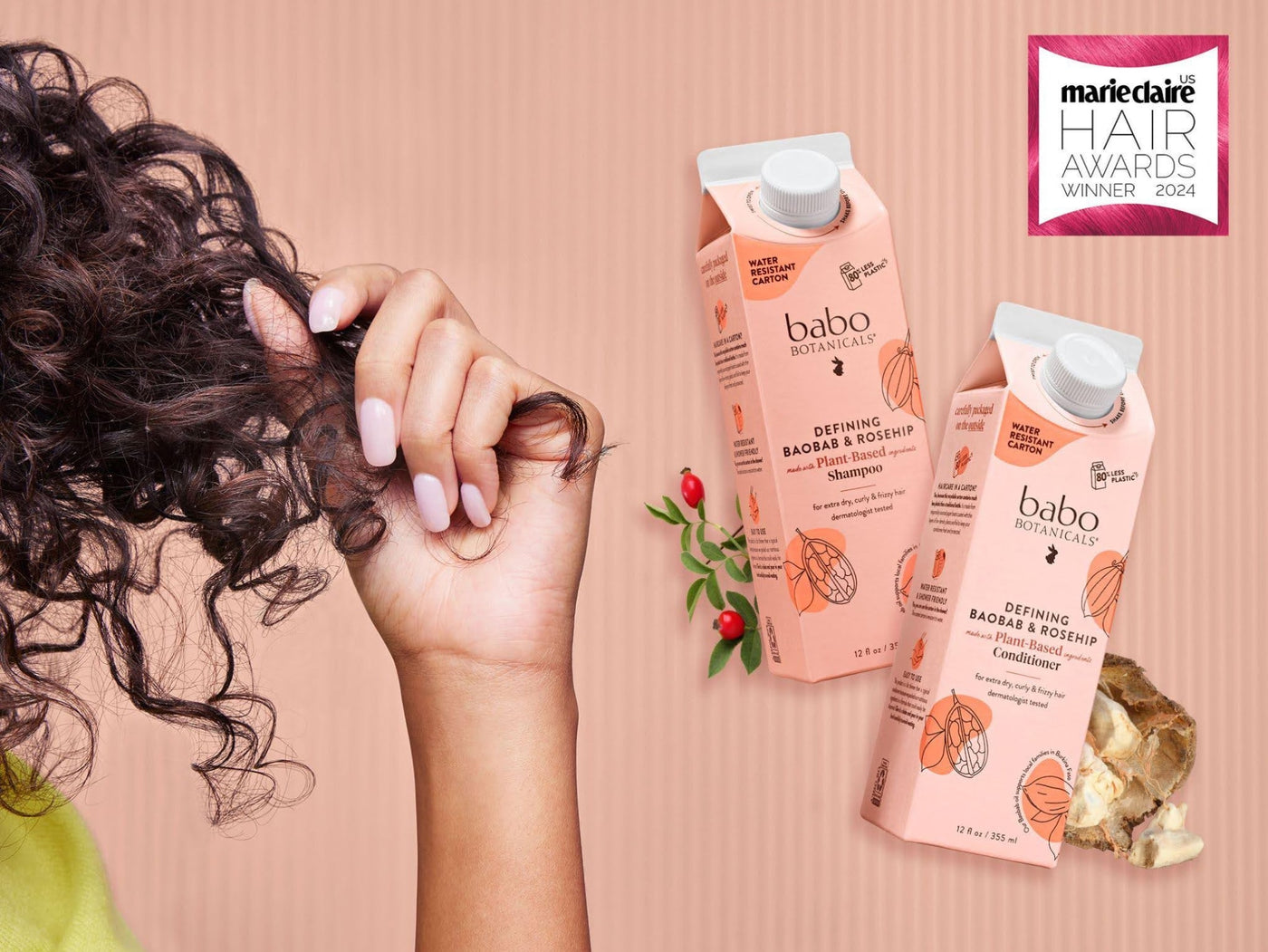 Babo Botanicals- defining Baobab & rosehip Shampoo & conditioner- Woman Holding curly hair next to shampoo- Maire Clair Hair Awards Winner 2024