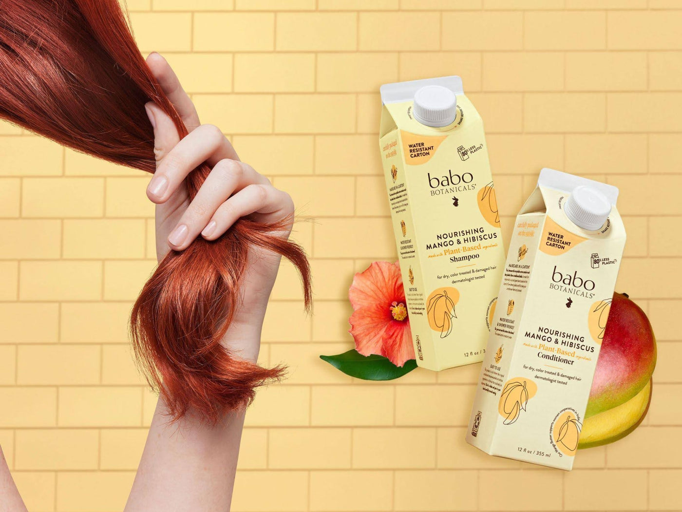 Babo Botanicals- Nourishing mango & Hibiscus Shampoo & Conditioner- Woman holding her hair next to shampoo & conditioner