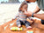 Babo Botanicals- Dad applying sunscreen stick to baby at the beach